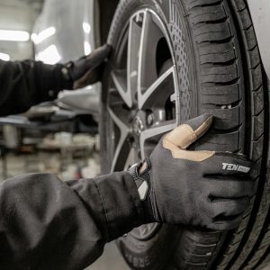 a man working on a tire in a garage